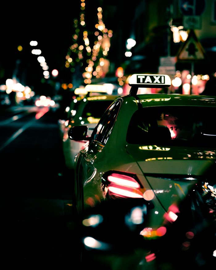 Night street view of lined up taxis in Düsseldorf, creating a vibrant urban atmosphere.